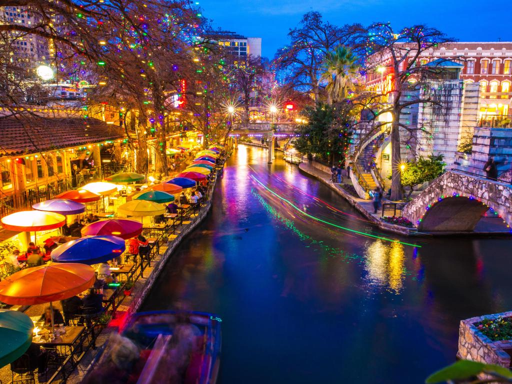 Lively winter night at River Walk in San Antonio in Texas with restaurants and buildings lit up