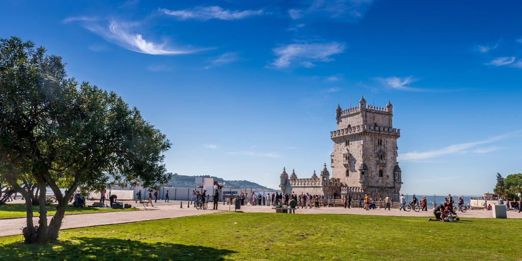 Belem Tower, Lisbon behind a green lawn and against a blue sky 