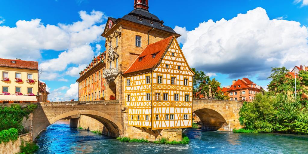 View of the yellow timbered City Hall building in Bamberg, Germany, with the river below it