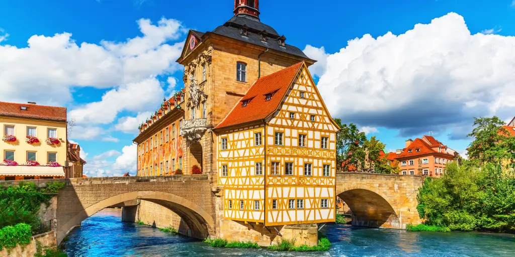 View of the yellow timbered City Hall building in Bamberg, Germany, with the river below it