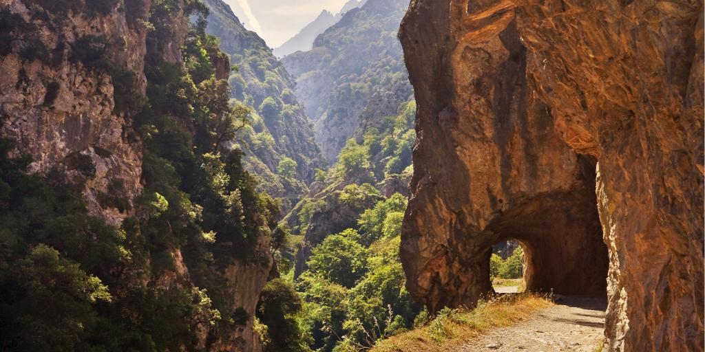 A path cuts through a mountain on the Ruta del Cares in Picos de Europa park, Spain