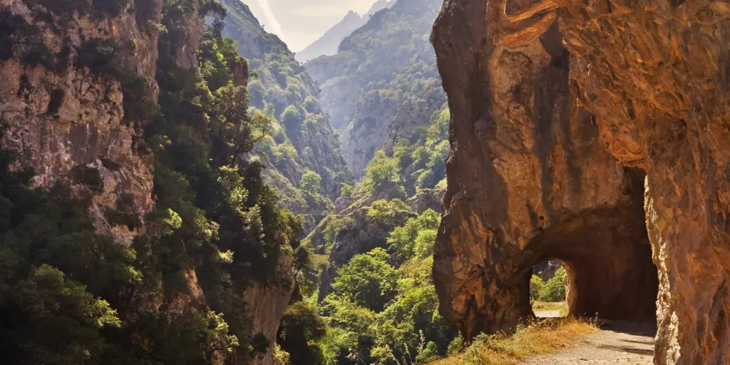 A path cuts through a mountain on the Ruta del Cares in Picos de Europa park, Spain