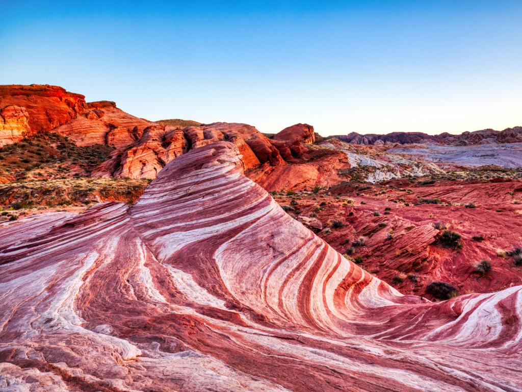 Valley of Fire State Park, Nevada, USA with the Fire Wave taken at Sunset  and surrounded by red rocks in the distance.