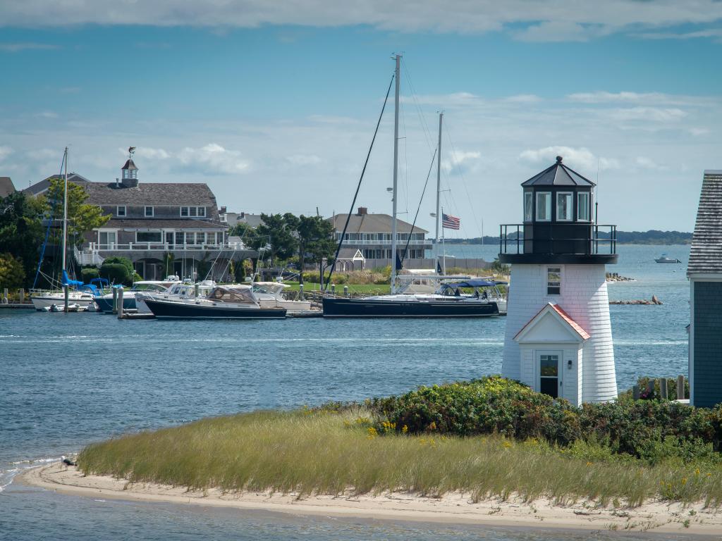 Hyannis harbor lighthouse in mid summer, showing a mini lighthouse in the foreground