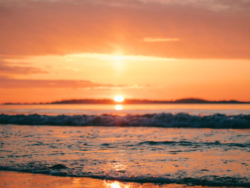 The sun rising over Nahant, MA, captured from Revere Beach.