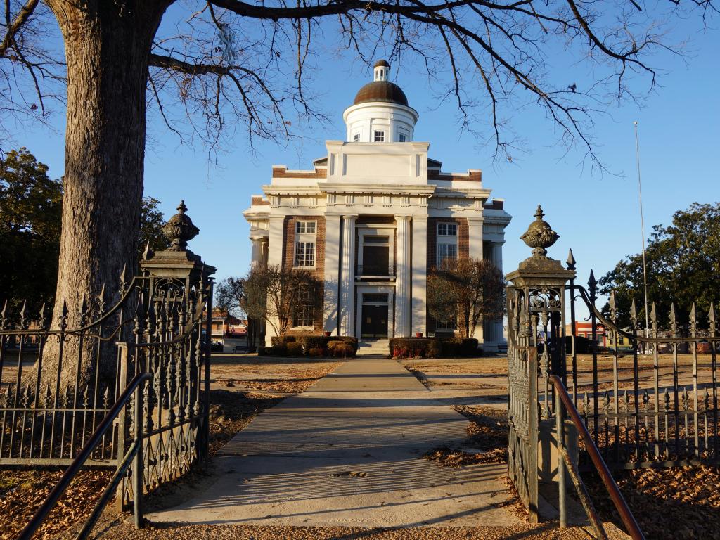 Exterior of the Madison County Courthouse, photo taken from the gates on a sunny day