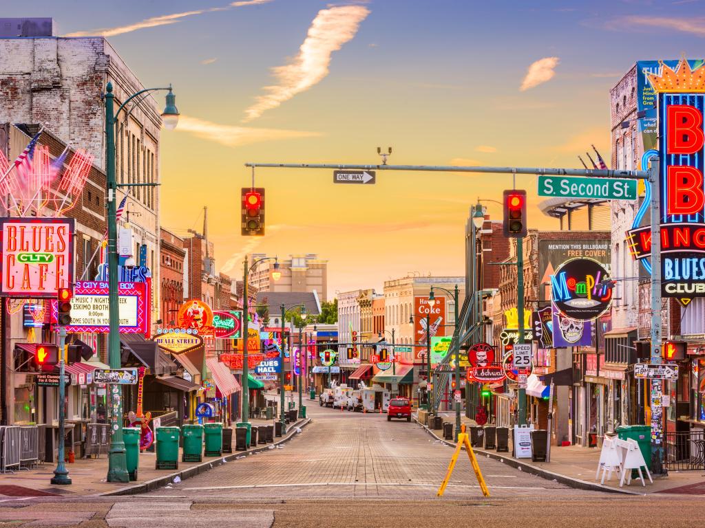 Neon city scape of Memphis with a variety of shop fronts, signs and advertisements 