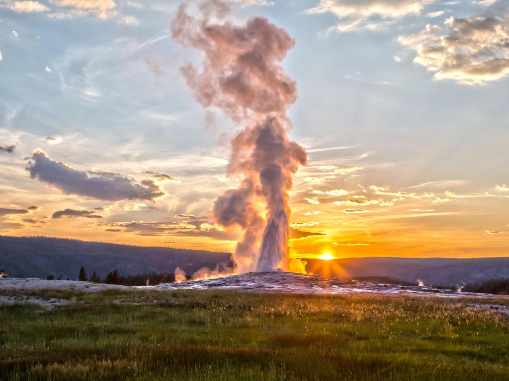 Old Faithful Geyser Eruption in Yellowstone National Park at Sunset