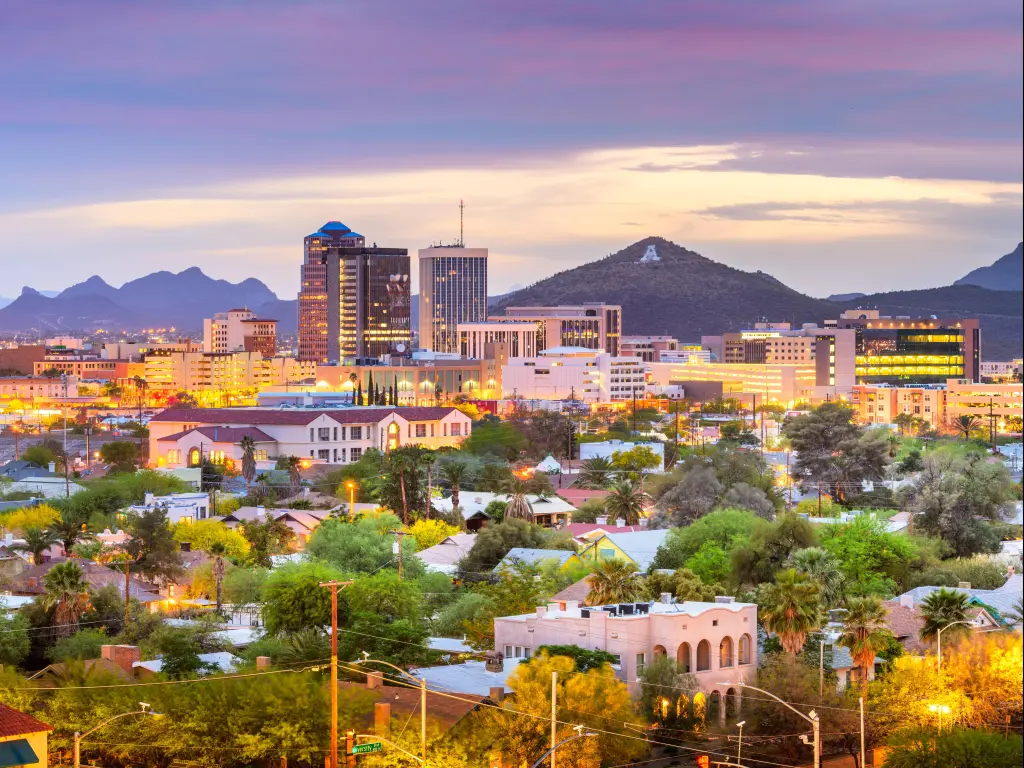 Tucson, Arizona, USA with the downtown city skyline and mountains in the background with "A" for Arizona on one mountain at twilight.