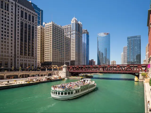 The Chicago River and downtown Chicago, USA on a sunny day with a boat in the foreground.