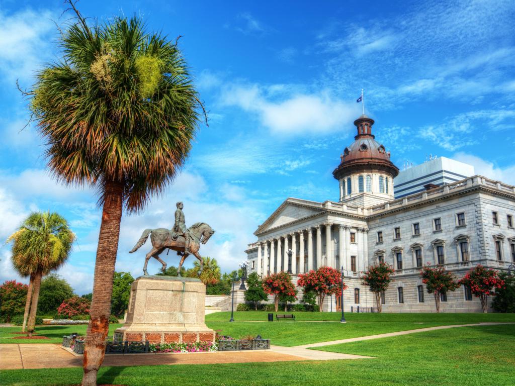 Columbia, South Carolina, USA with a view of the South Carolina State House in Columbia on a sunny day.