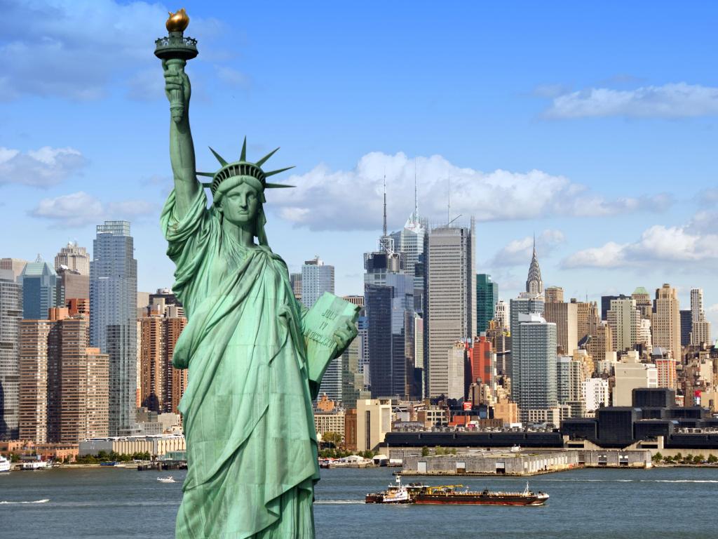 New York city skyline city. with midtown Manhattan skyscrapers and freight sailing ship, USA