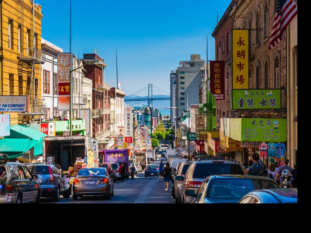 A street in Chinatown in San Francisco with the Oakland Bay Bridge in the background