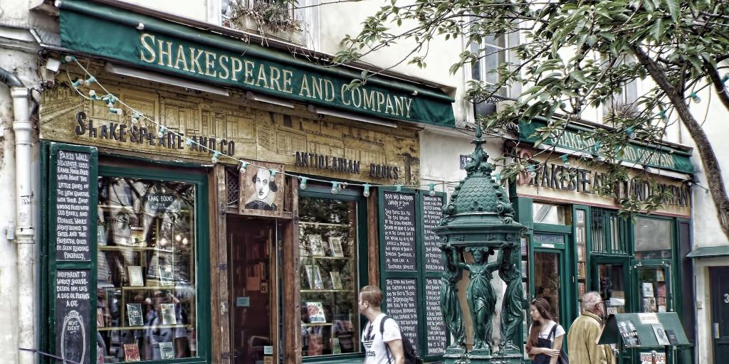 Passers-by look in the window of Shakespeare and Company bookshop