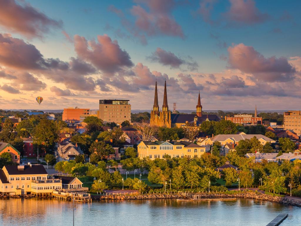 Charlottetown, Prince Edward Island, Canada taken as a view of the city from the sea at early evening, with a hot air balloon in the distance. 