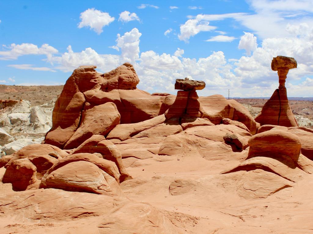 Toadstool Hoodoos, Utah, USA with a view of the Grand Staircase of the Escalante on a sunny day.