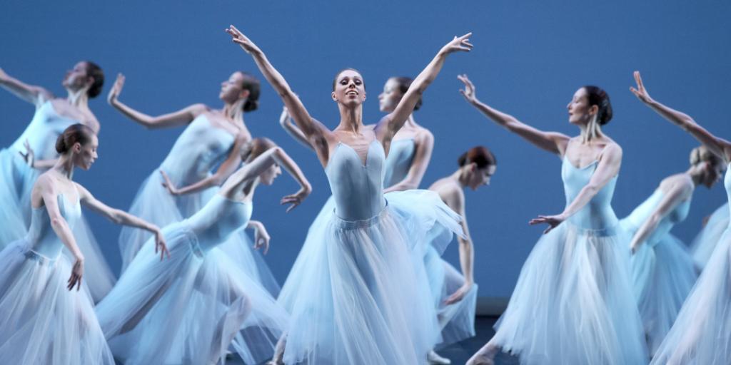 Ballet dancers in white outfits onstage at the Bolshoi Theatre, Moscow