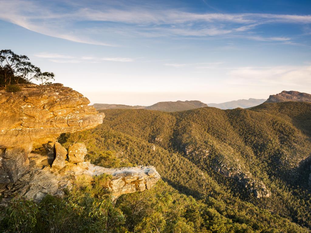 Grampians National Park, Victoria, Australia taken at the Balconies lookout on a clear sunny day with tree covered mountains in the distance.