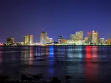 New Orleans, Louisiana, USA with the city downtown in the background and the Mississippi River in the foreground at twilight.