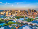 Downtown Nashville, Tennessee, USA. This aerial shot depicts The Gateway Bridge with a backdrop of the city as the sky gets darker.