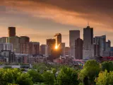 Denver skyline, sun setting behind the skyscrapers