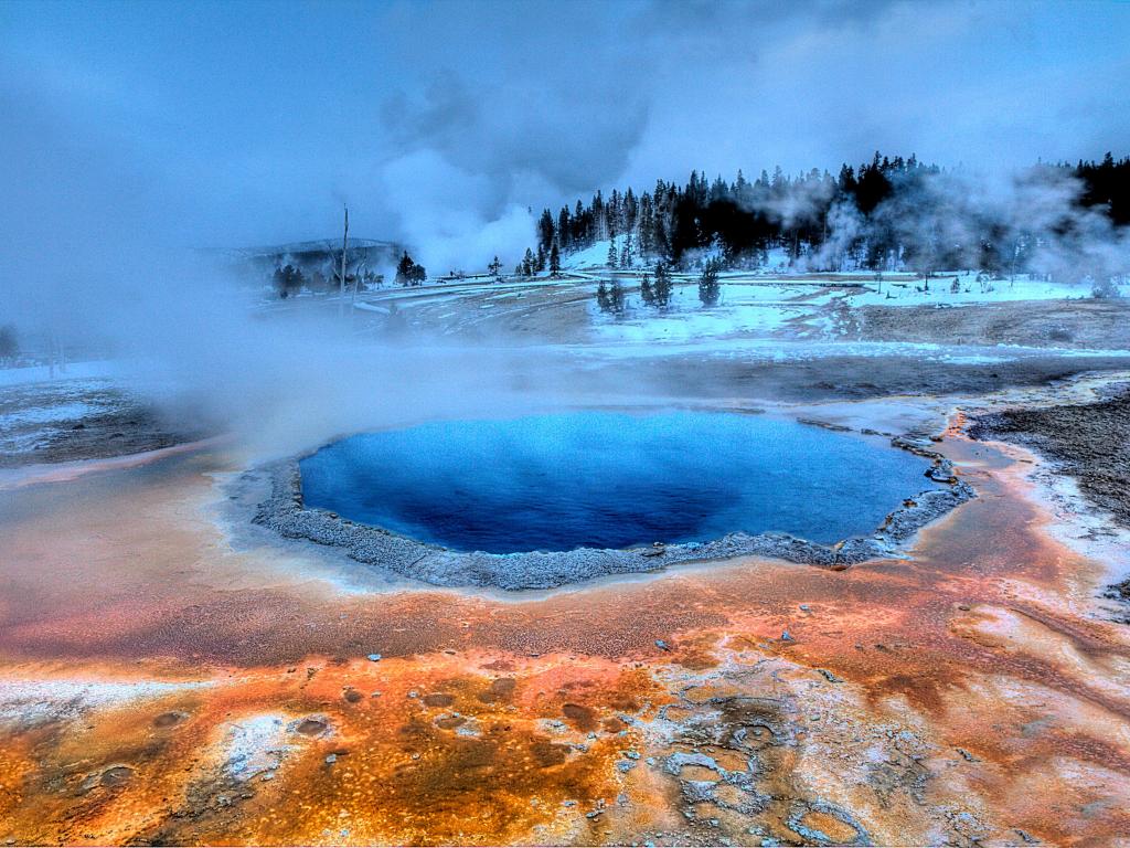 Yellowstone National Park, Wyoming, USA taken during winter with steam, the volcanic terrain and pools, taken at early evening.