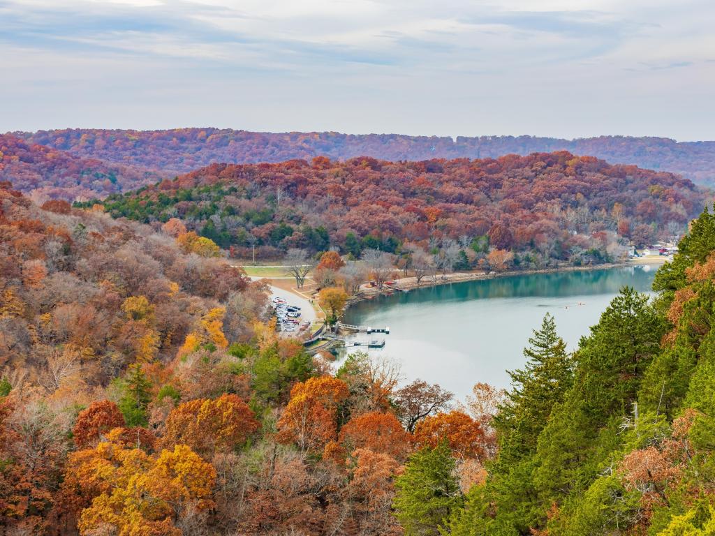 Lake of the Ozarks State Park, with an aerial view of the Lake Ozark at Missouri with trees in fall colors surrounding it.