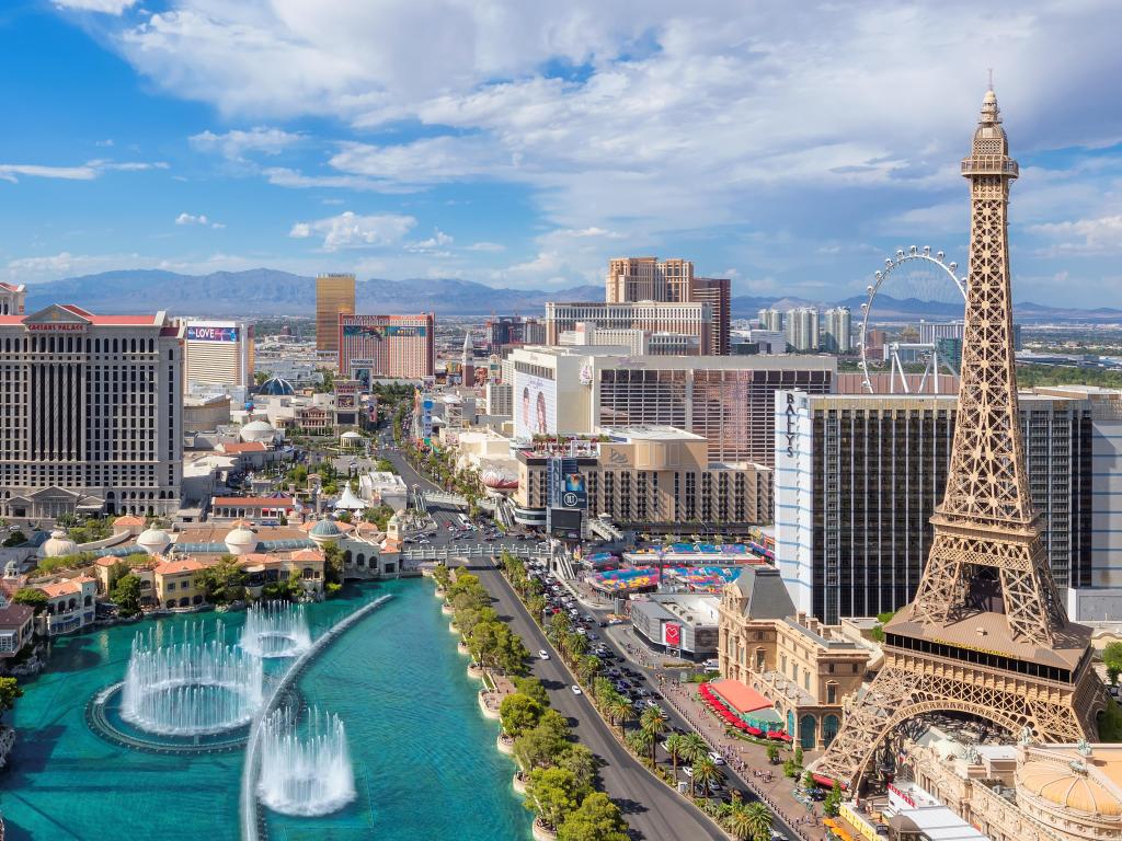 Las Vegas, USA taken as a panoramic view of Las Vegas Strip as seen at sunny day, with views of hotels and casinos and a beautiful water feature in the centre. 