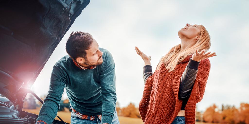 Couple arguing on the road while having problem with a broken down car