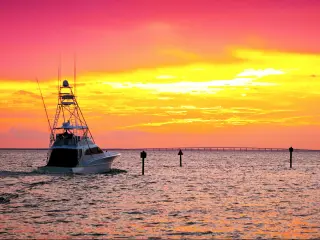 Large fishing boat going out for a sunset cruise in Destin, Florida.