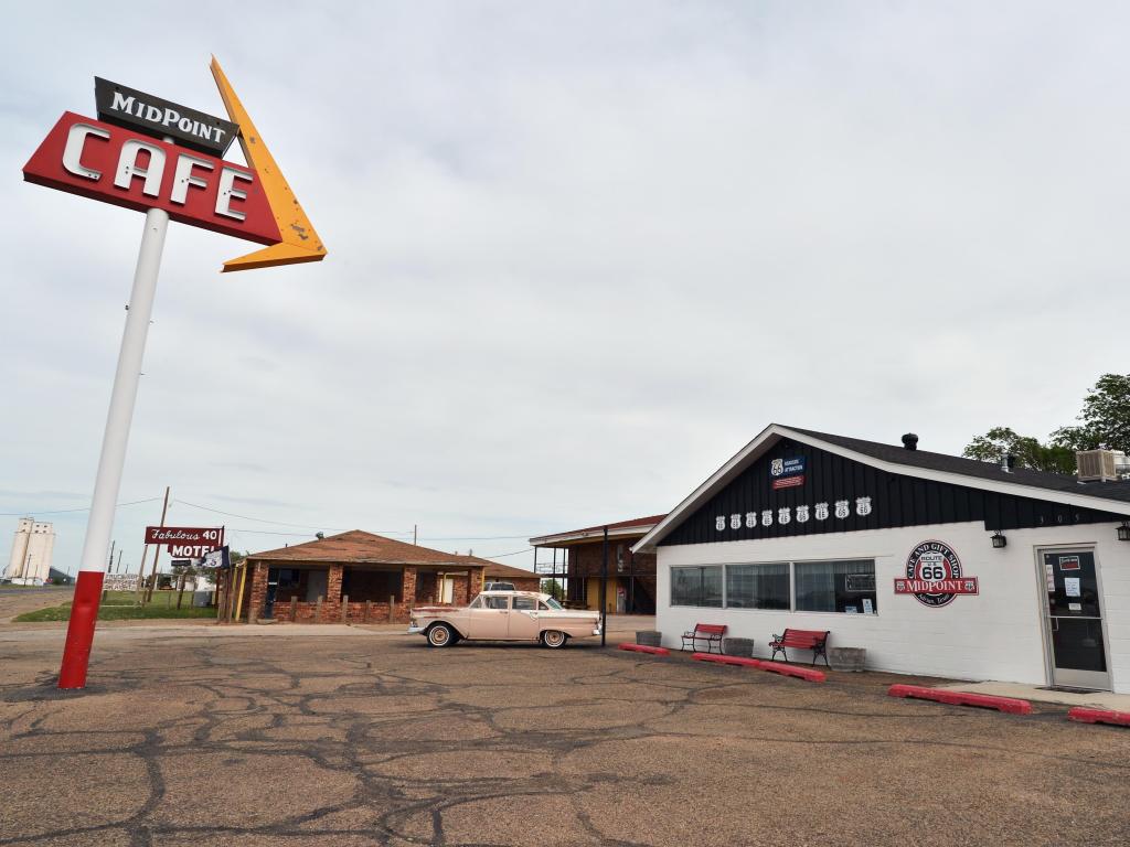 The small building of Midpoint Cafe and its sign on an overcast day