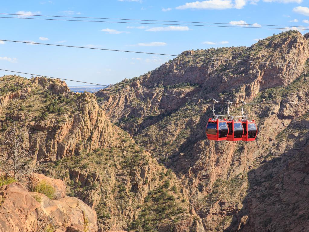 A red gondola ascends over the Royal Gorge near Cañon City, Colorado