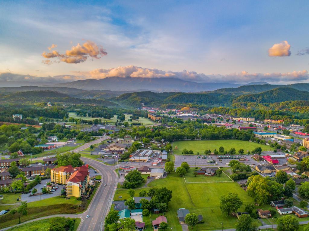 Pigeon Forge, Tennessee, USA and Sevierville taken as an aerial view with the town and mountains in the distance. 