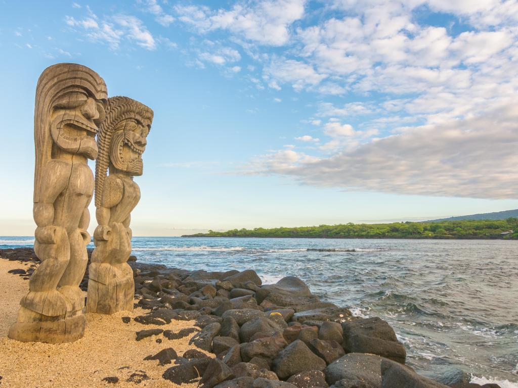 Tiki Statues stand on the beach in Pu'uhonua O Honaunau National Historical Park, Big Island, Hawaii