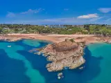 Aerial Drone image of Portelet Bay, Jersey, Channel Islands with blue sky and calm water.