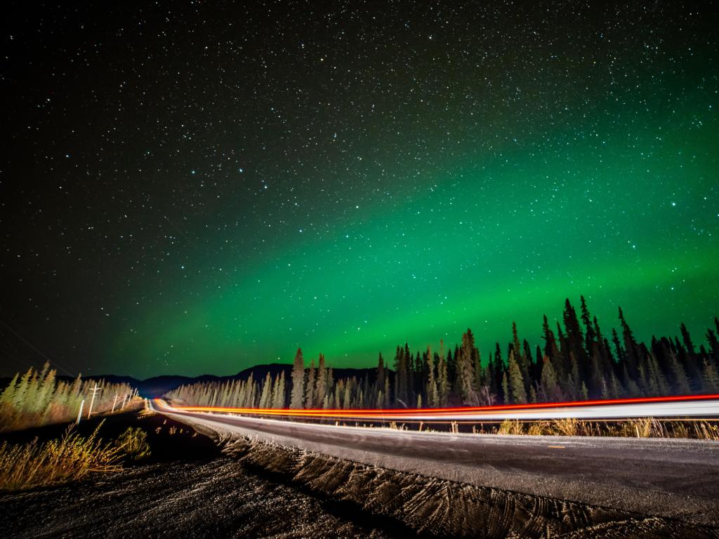 Green, beautiful northern lights seen along the Alaska Highway in Yukon Territory, Canada.
