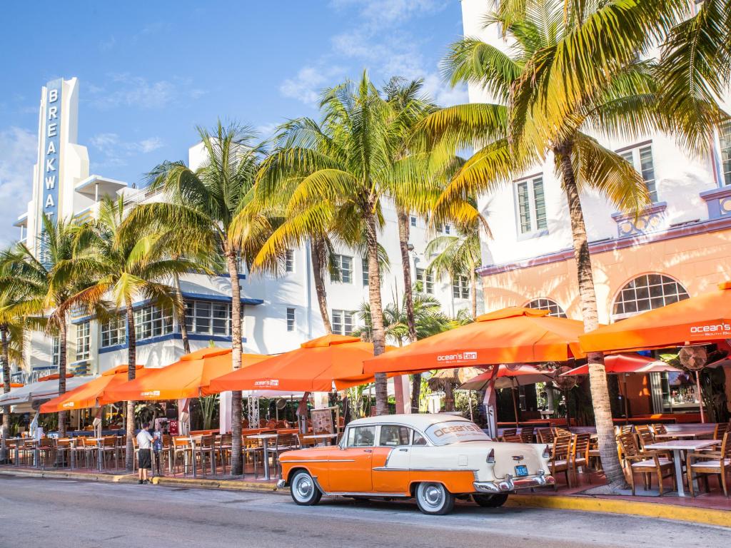 Ocean Drive in Miami Florida, with a vintage car parked on the palm-lined street