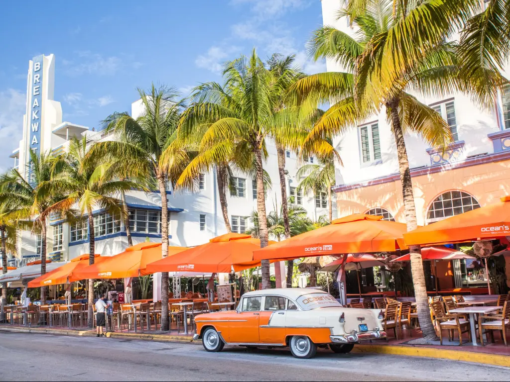 Ocean Drive in Miami Florida, with a vintage car parked on the palm-lined street