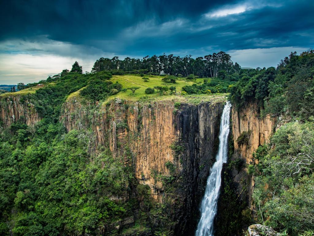 The Howick Waterfall at Howick in KwaZulu-Natal in South Africa taken on a cloudy day with the incredible waterfall and vast cliffs either side.