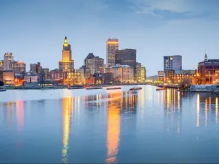 Providence, RI skyline at twilight with boats on the water and skyscrapers in the background