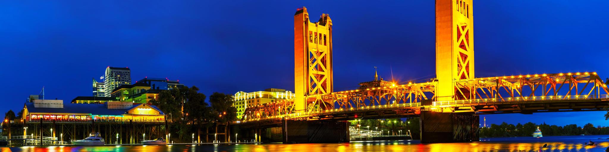 Sacramento, California, USA  with a panorama of Golden Gates drawbridge in Sacramento at night.