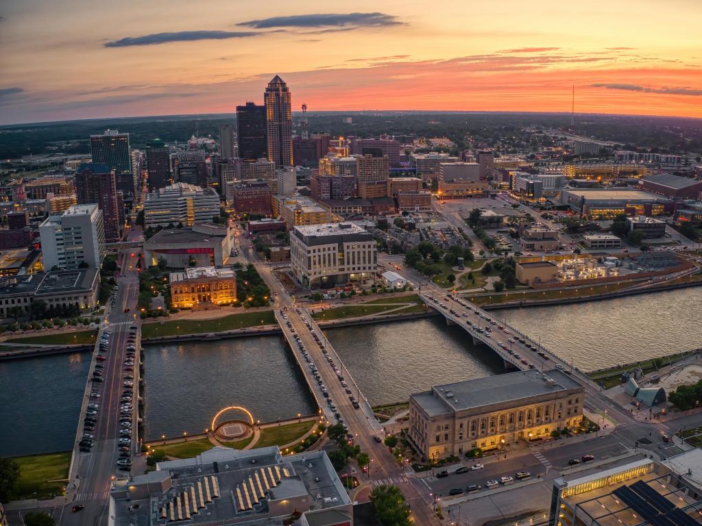 Aerial view of Des Moines, Iowa skyline at sunset, with bridges in the foreground