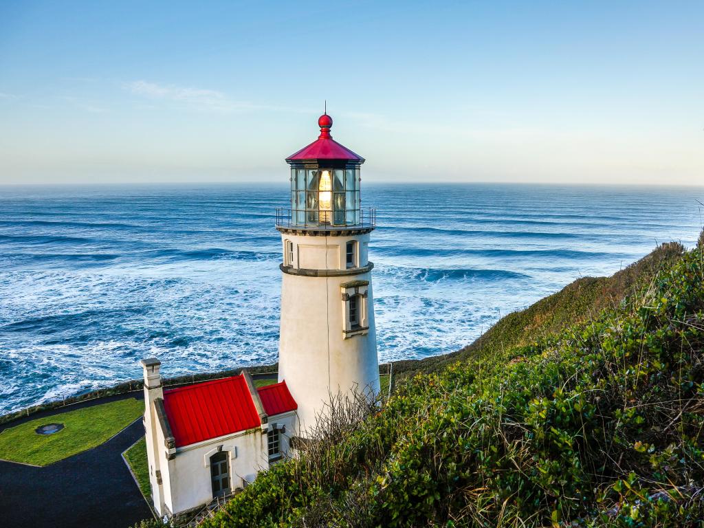 Heceta Head Lighthouse in Oregon with the blue sea and sky in the background on a clear day