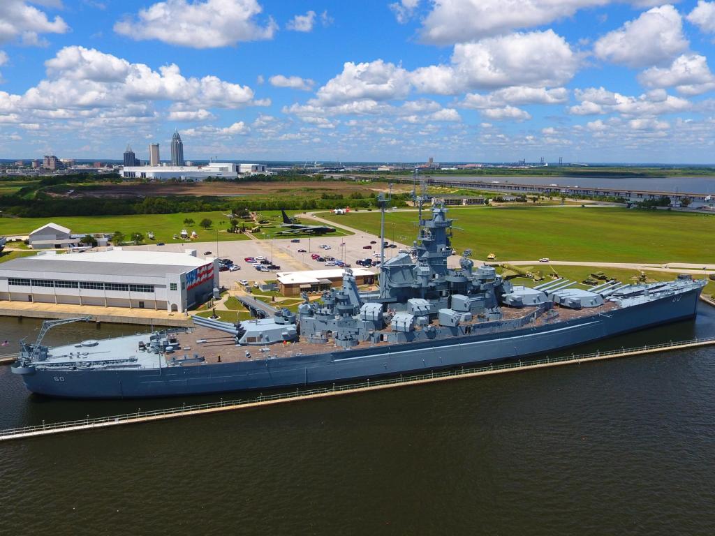 USS Alabama battleship in Mobile, Alabama on a blue but cloudy day.