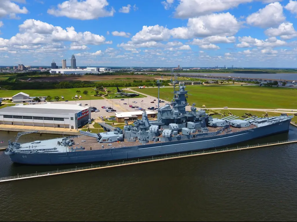 USS Alabama battleship in Mobile, Alabama on a blue but cloudy day.