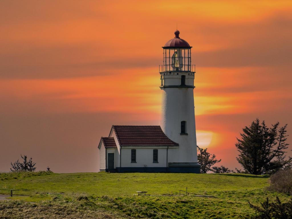 White lighthouse with vivid orange sunset