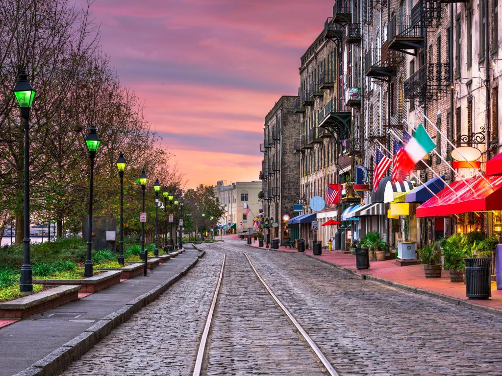 Savannah, Georgia, USA with the iconic bars and restaurants on River Street taken at early evening.