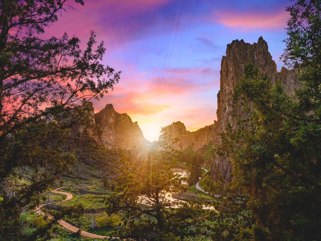 Rock Smith State Park at sunset near Bend, Oregon, with the last rays of sun flaring through the rugged rocks on the horizon