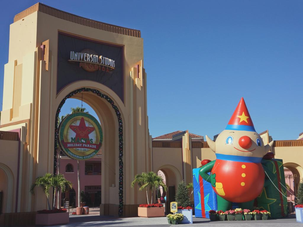 The Entrance of the Universal Studios Orlando with Christmas decoration under the clear, blue sky in December.