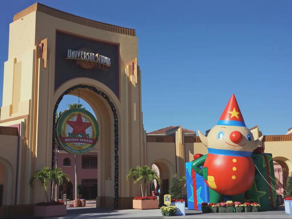 The Entrance of the Universal Studios Orlando with Christmas decoration under the clear, blue sky in December.